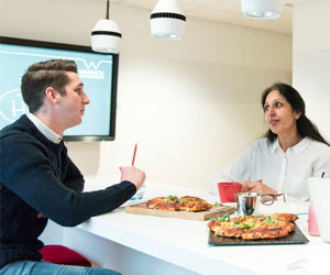 An image of a meeting taking place on the breakfast bar of The Small Kitchen