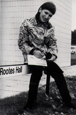A student sitting on a Rootes sign in the late 1960s