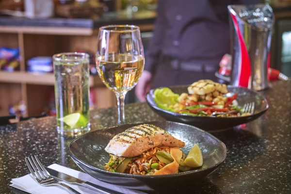 Salmon dish served with a glass of wine